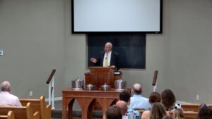 Speaker preaching from the pulpit on whether there is anyone God cannot help